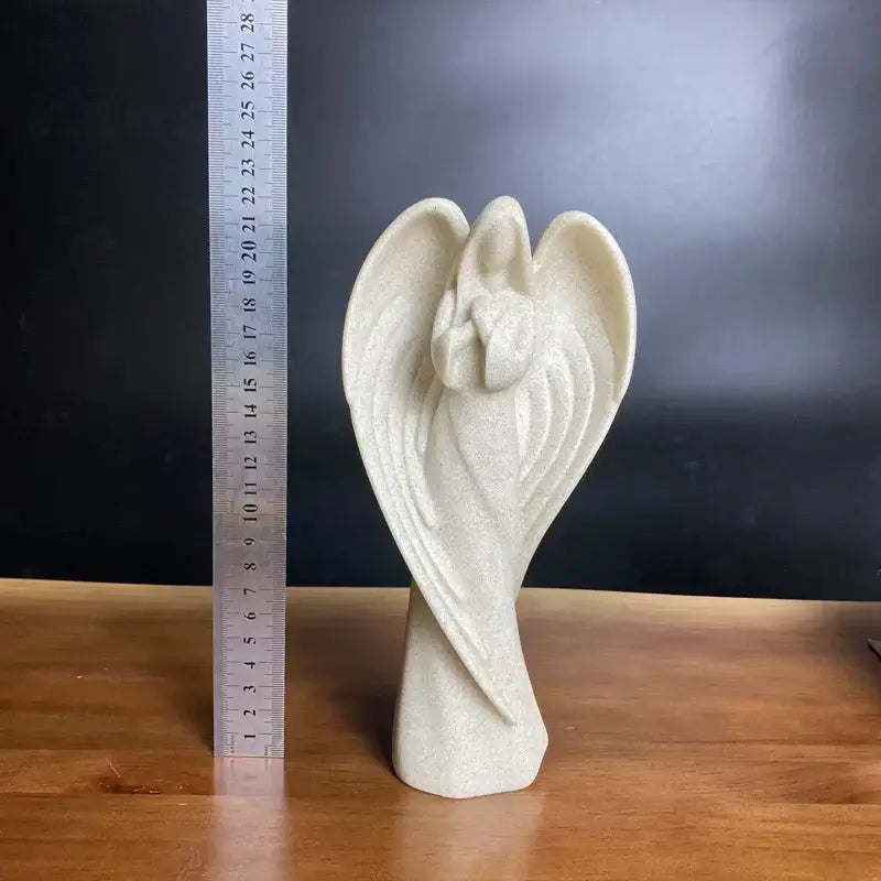 Delicate off-white resin statue of an angel wing girl with gracefully curved wings and textured stone-like finish