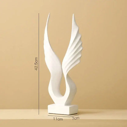 White ceramic angel wings sculpture with flowing forms on a square base for Nordic modern home decor