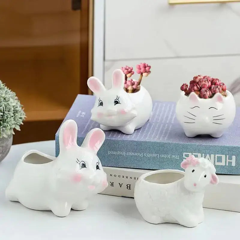 White ceramic animal cartoon ceramic planters featuring cute bunny and cat designs with pink accents for nursery planting