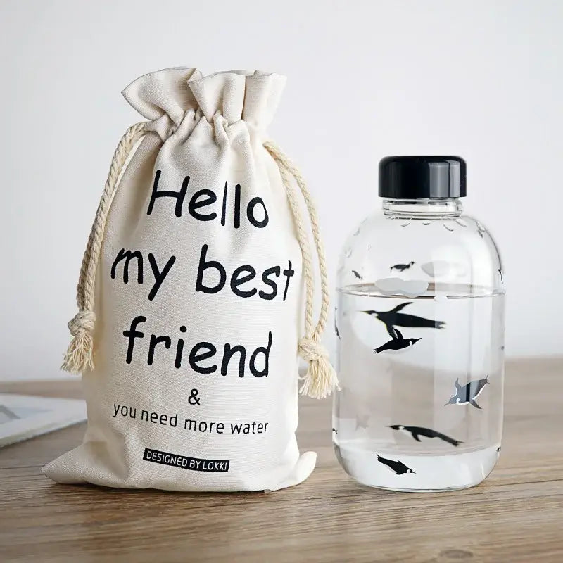 Cream-colored canvas drawstring bag with black text and lokki label for decorbites glass water bottle sleeve