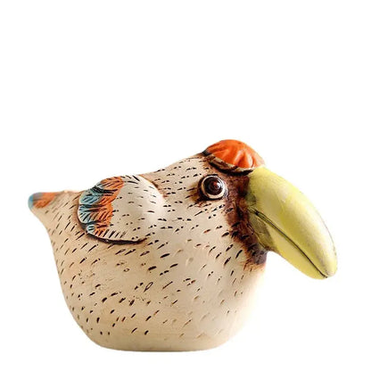 A charming ceramic animal vase succulent featuring a beige textured toucan with a vibrant yellow beak and orange crest
