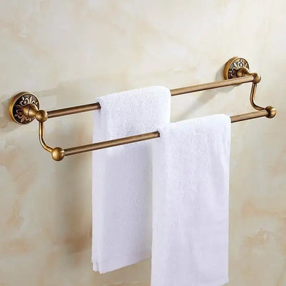 Antique brass double towel rack with ornate floral mounts and polished finials for bath hardware and toilet brush holder