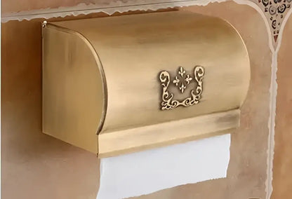 Gold-colored ornate metal toilet paper holder with fleur-de-lis emblem from decorbites™ bath hardware set with towel rack and toilet brush holder