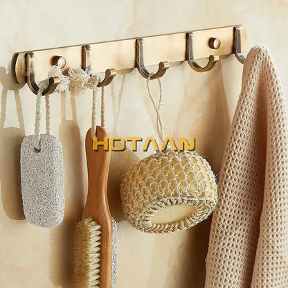 Bronze-colored metal wall-mounted decorbites antique black robe hook rack with five hooks holding bath accessories