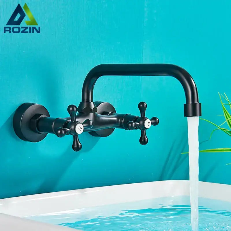 Black matte finish wall-mounted basin faucet with dual cross handles and curved spout by decorbites antique brass