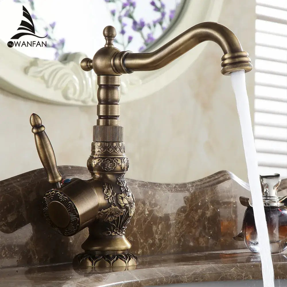 Antique brass basin faucet decorbites antique brass finished with ornate floral engraving and a curved spout