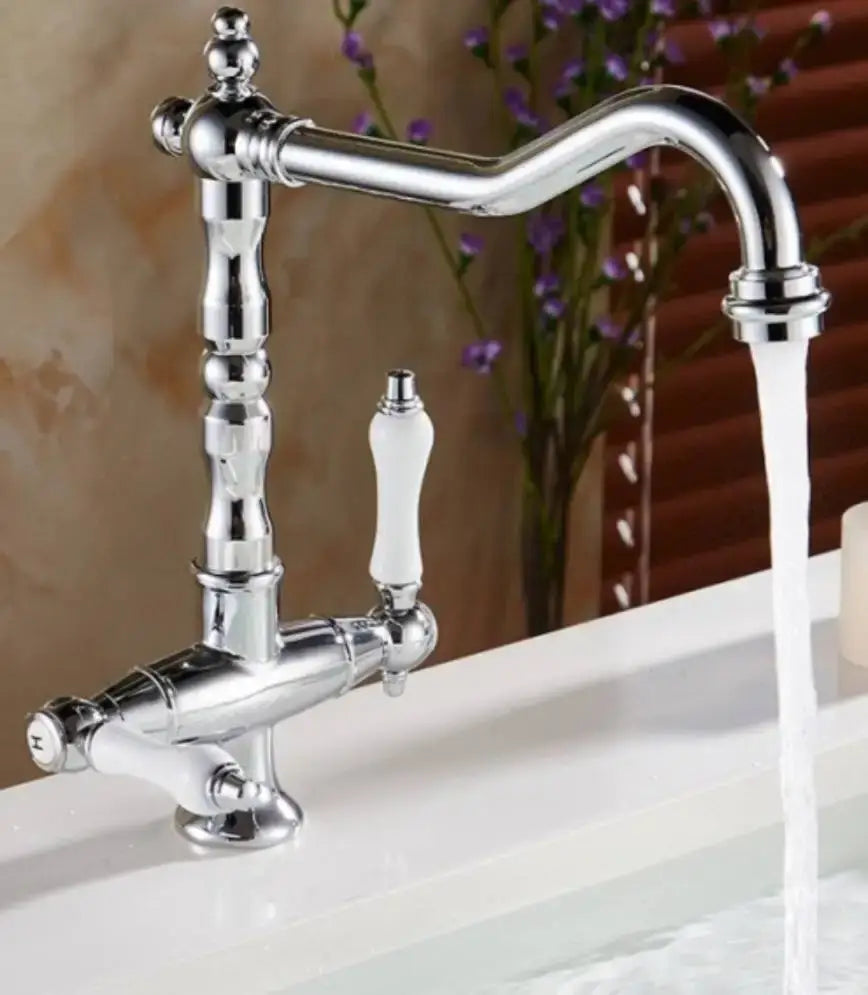 Chrome-finished kitchen faucet with curved spout and white ceramic handles in DecorBites™ antique brass bathroom faucet set