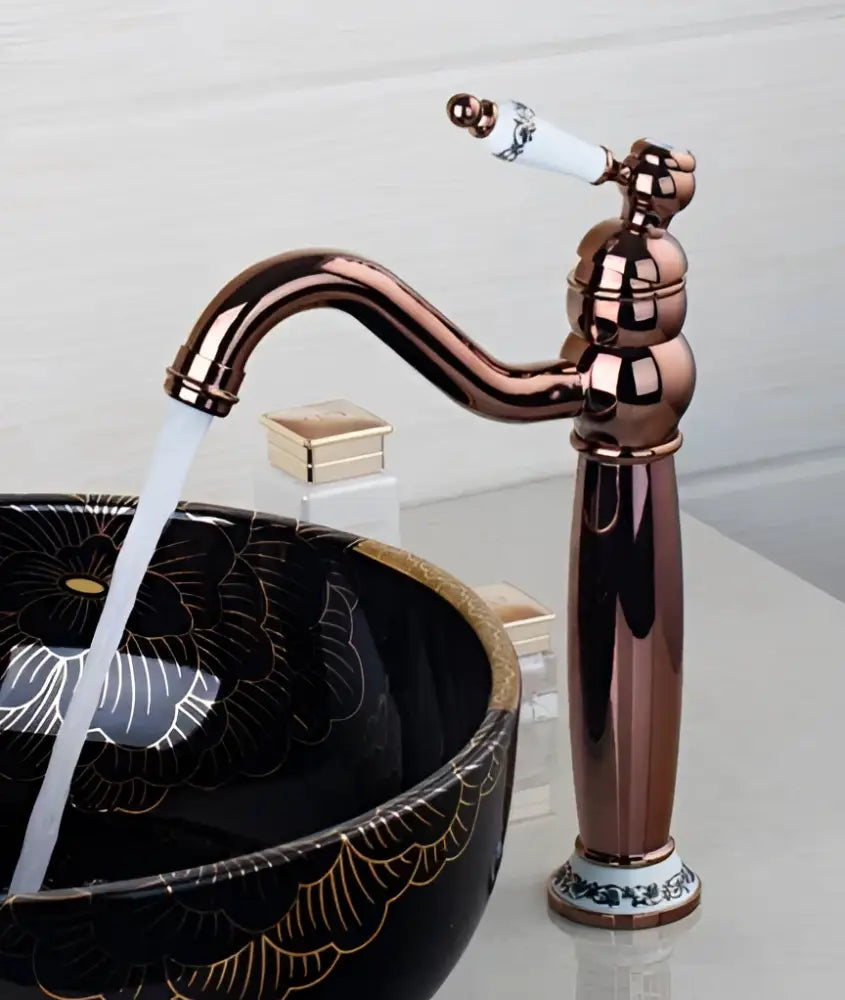Rose gold faucet with white ceramic handle and ornate detailing from DecorBites antique brass bathroom faucet set