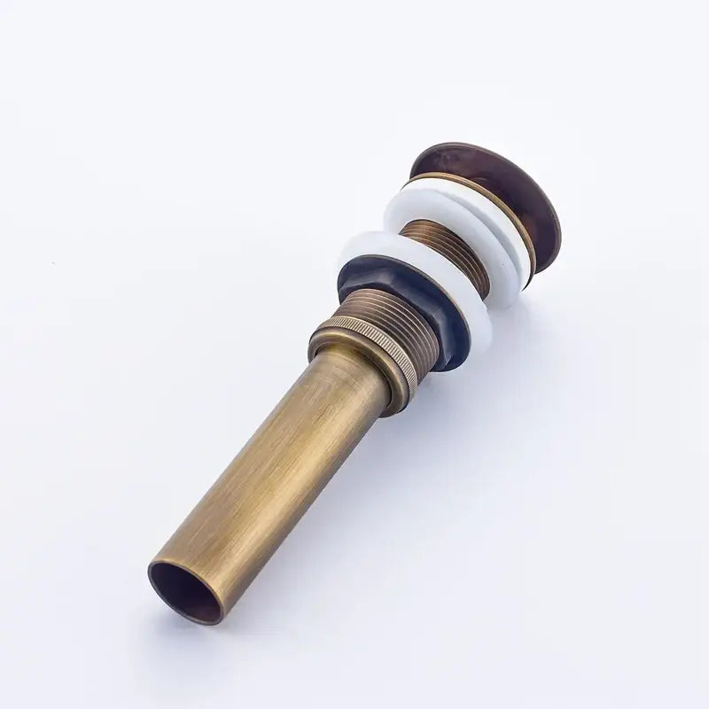 Antique brass bathroom sink pop up drain with dark wood and white ceramic stopper for vessel sink by decorbites