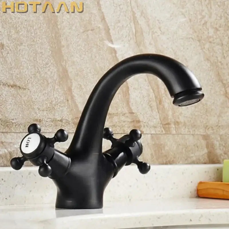 Black matte-finish double handle faucet with curved spout and cross-shaped handles for bathroom basin mixer