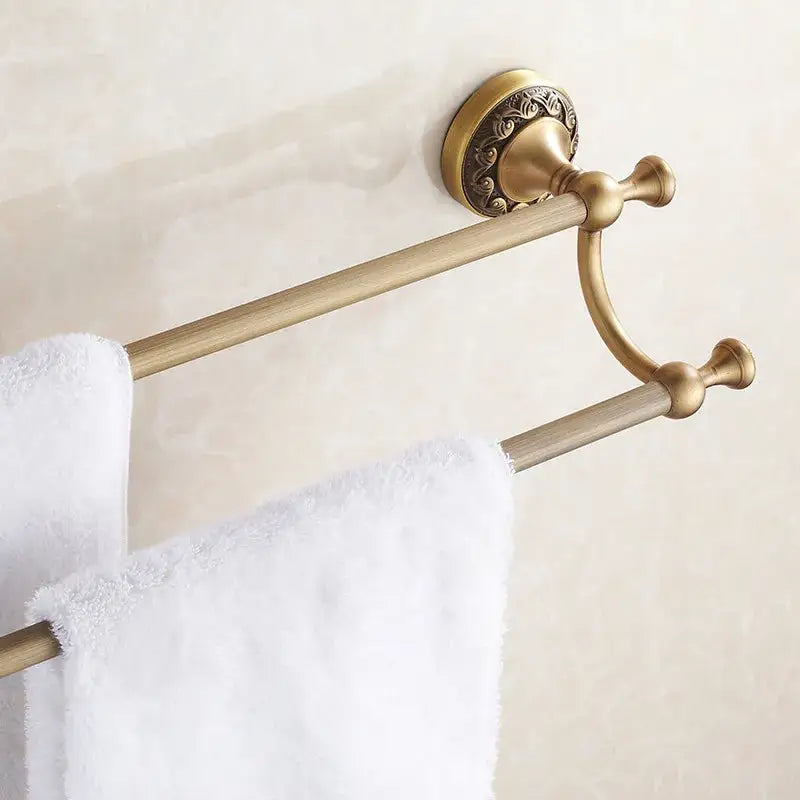 DecorBites™ antique brass double towel bar with ornate circular wall mount and polished finish bathroom towel rack