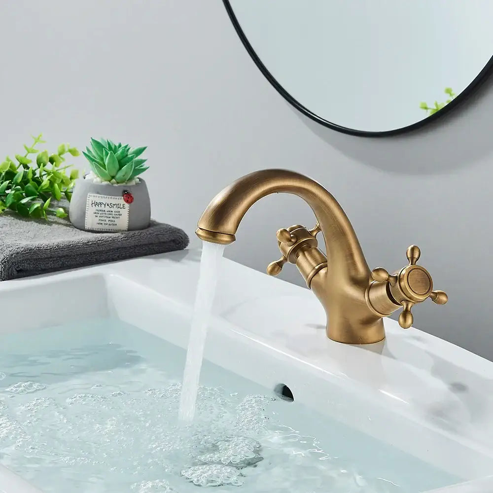DecorBites antique brass dual handle basin faucet with ornate cross handles and curved spout for bathroom use