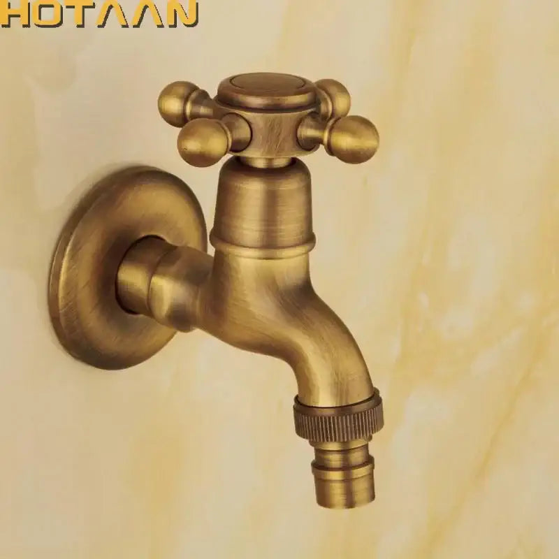 DecorBites™ antique brass finish wall mount garden bibcock faucet with cross-shaped handle and decorative spherical knobs