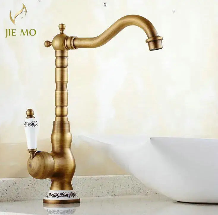 DecorBites antique brass porcelain basin mixer with white ceramic handle and ornate black floral detailing, 360 swivel faucet