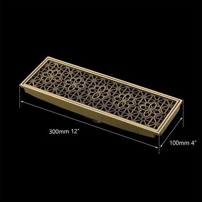 DecorBites™ antique brass rectangular floor drain strainer with intricate floral and geometric cutout patterns for deodorization