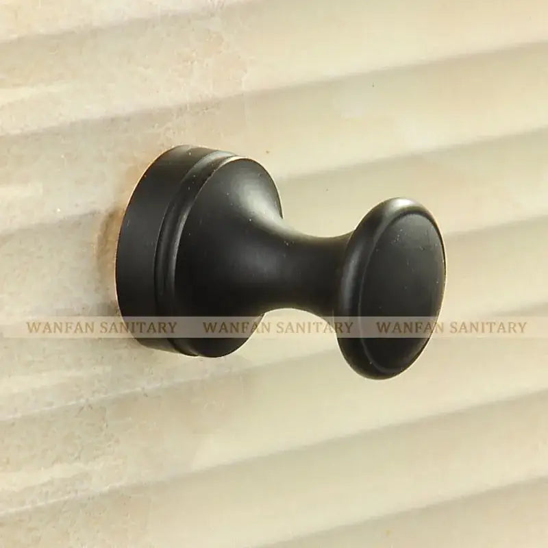 Black matte-finished metal towel rack with classic rounded design suitable as a robe hook or brass robe hook alternative