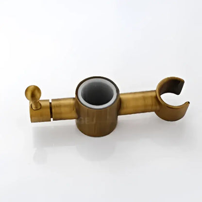 Gold-colored metal clothing rack with central cylindrical hole and curved hooks in decorbites antique brass shower set