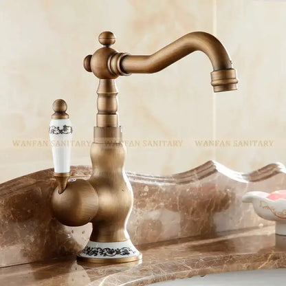 DecorBites™ antique brass single handle basin faucet with white ceramic handle and black floral patterned base
