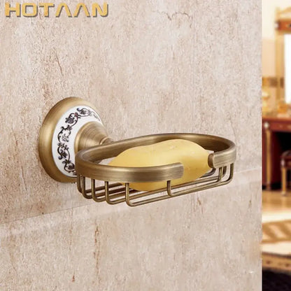 Decorbites antique brass soap holder with decorative white ceramic base featuring black floral patterns and brass soap holder details