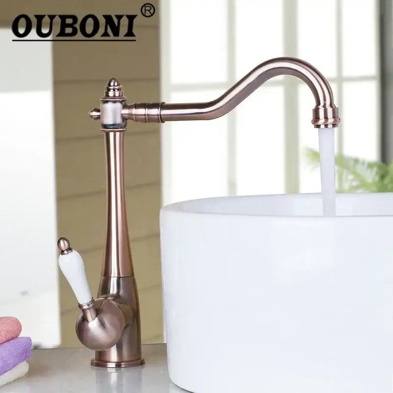 Decorbites antique brass swivel kitchen faucet with curved spout and white ceramic handle for countertop sink