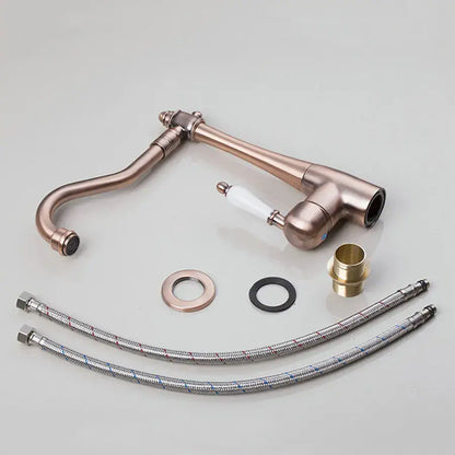 Decorbites™ antique brass swivel kitchen faucet with white ceramic handle and flexible metal hoses for countertop sink