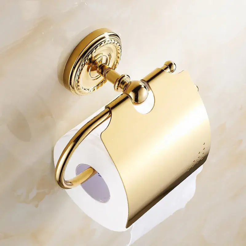 Decorbites antique brass toilet paper holder wall mount in gold-finished brass with ornate design and curved paper holder
