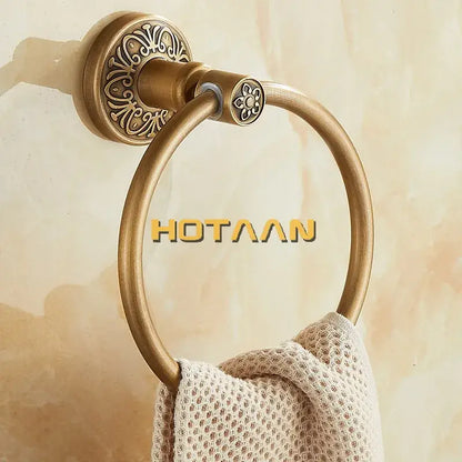 Decorbites antique brass towel ring with ornate floral mounting plate and circular hoop for bathroom wall mounting