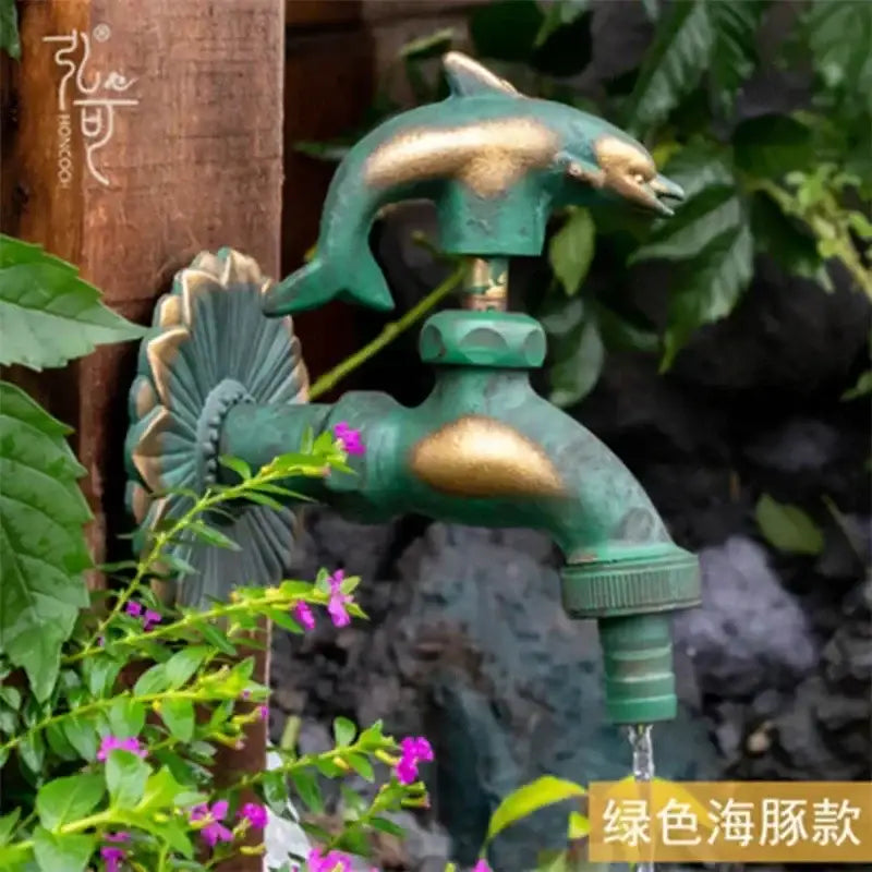 DecorBites™ antique brass wall mount garden faucet with green dolphin design and decorative shell brass accents