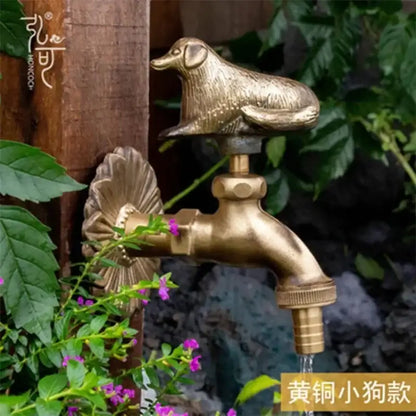 DecorBites™ antique brass wall mount garden faucet with detailed dog figurine cap and ornate fluted design