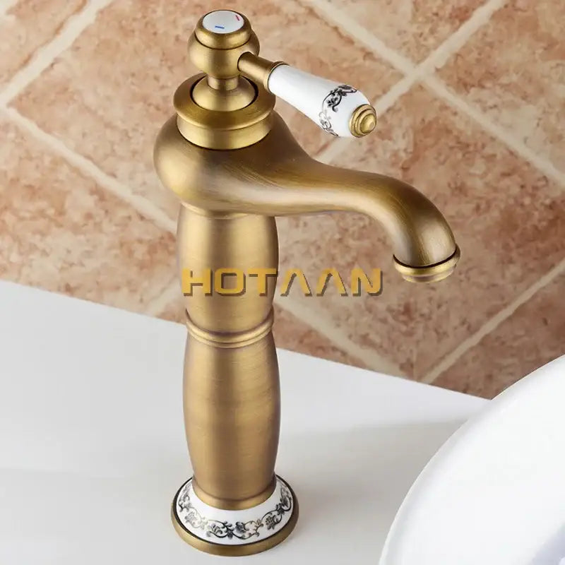 Antique bronze brass basin faucet with white ceramic handle and black ornate detailing by decorbites luxury europe style mixer tap