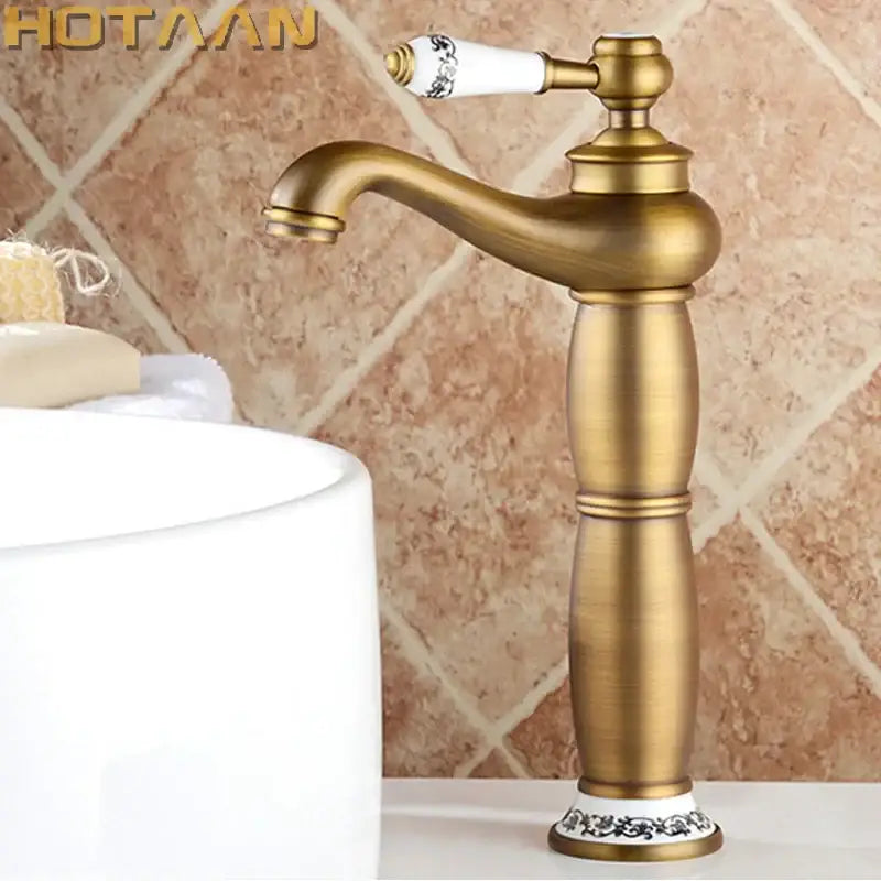 Decorbites antique bronze brass basin faucet with white ceramic handle and base featuring black floral patterns