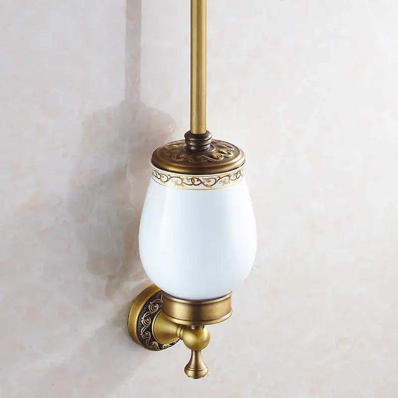DecorBites™ antique bronze brass toilet brush holder with white ceramic bowl and ornate gold detailing for bathroom use