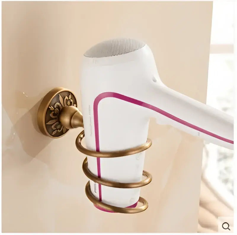 White hair dryer with magenta stripe in an ornate brass holder from decorbites antique bronze bathroom accessories set