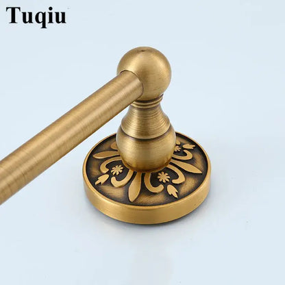Antique brass-finished towel rack with ornate floral engraving on circular base from decorbites bathroom accessories set