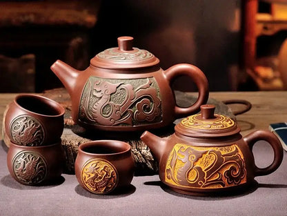 Brown ceramic antique bronze teapot with intricate dragon carvings and greenish gold panel from bronze teapot set