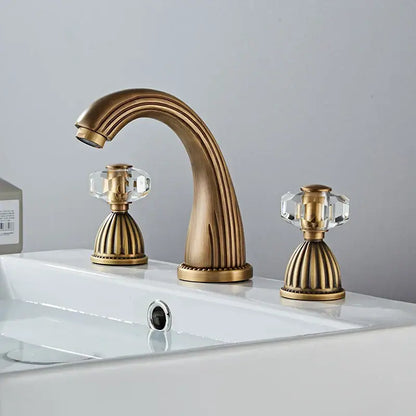 Decorbites antique bronze widespread basin faucet with three brass handles and crystal knob accents for bathroom use