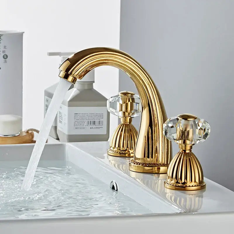 DecorBites antique bronze widespread basin faucet with gold finish crystal knobs and ornate fluted base detailing