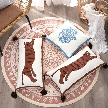 White rectangular pillow cover with antique brown tiger print, blue embroidery, and dark brown tassels by DecorBites™