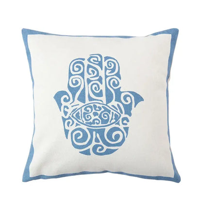Decorbites™ pillow cover with white fabric base and blue embroidered hamsa design, complementing antique brown tiger print style