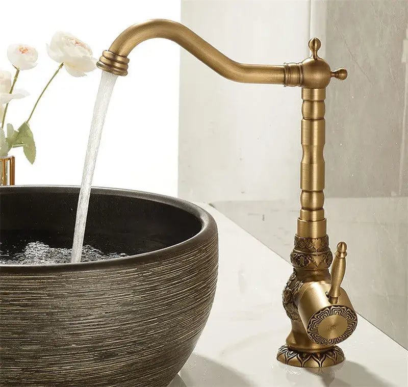 Decorbites™ antique carved brass bathroom sink faucet with single handle and ornate detailing for hot and cold mixer