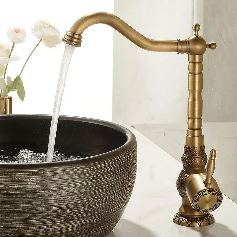 Decorbites antique carved brass bathroom sink faucet with ornate detailing and curved spout deck mounted tap