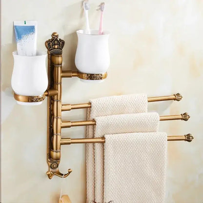 Antique brass-finished DecorBites towel rack with carved swivel towel bars and white ceramic toothbrush holders