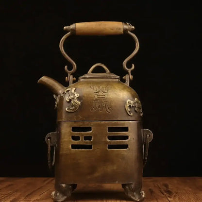 Antique brass warm wine pot with wooden handle, ornate dragon motifs, and Chinese character engravings from DecorBites™