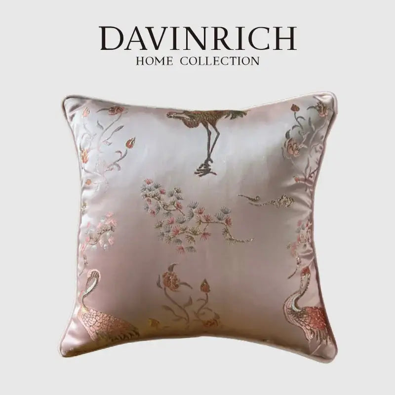 A soft pink satin pillow case from davinrich home featuring antique crane floral jacquard embroidery in gold tones