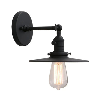 Black industrial wall sconce with antique finish featuring exposed filament bulb and wide shade with on off button