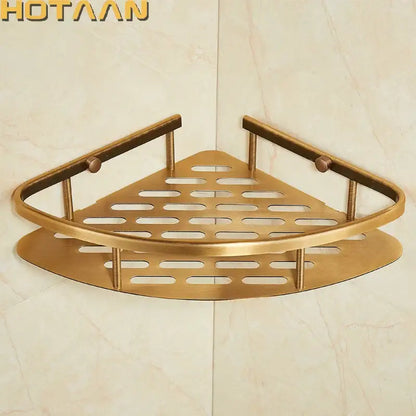 Brass-colored triangular corner shower caddy with antique finish aluminum and perforated design for bathroom organization