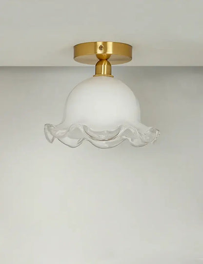 Decorbites antique glass ceiling light featuring a white frosted glass pendant with gold brass base and ruffled edge