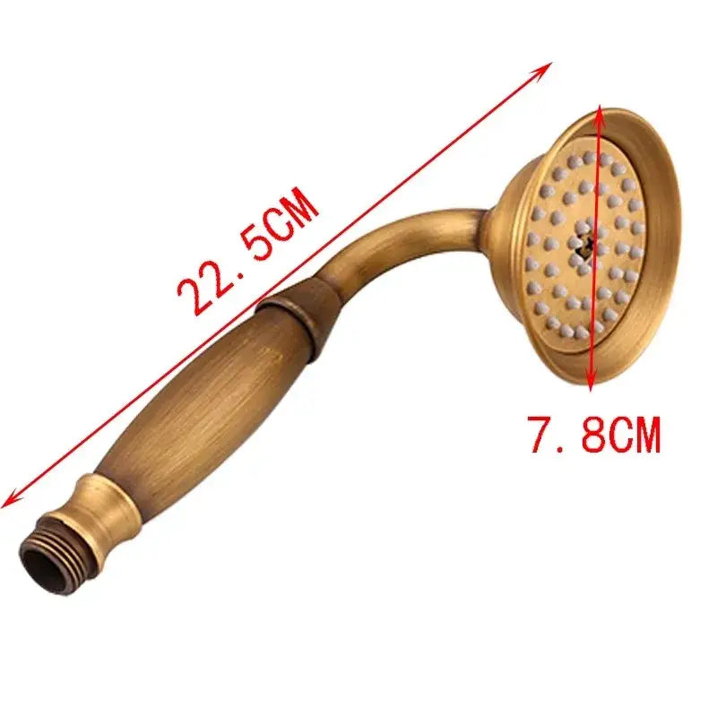 Decorbites™ antique gold handheld shower head with holder features an antique brass-finished curved handle and circular spray face
