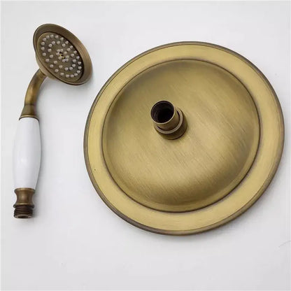 Decorbites antique handheld shower head set in antique brass with ceramic handle and matching mounting plate and hose
