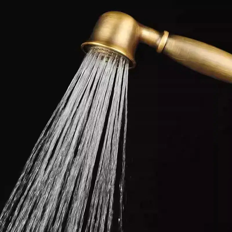 Antique handheld shower head by decorbites in brass with classic rounded design and multiple water streams flowing